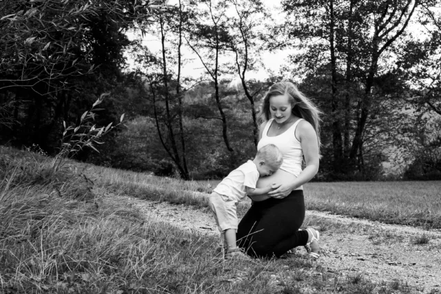 Bruder küsst Babybauch seiner ungeborenen Schhwester - Martin Schinnerl Fotografie